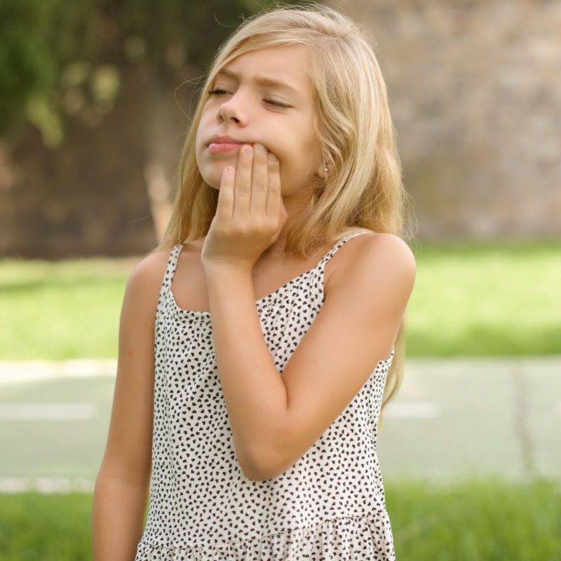 Little Girl Experiencing A Toothache Dental Emergency